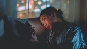 Eine junge Frau starrt auf ihr Handy